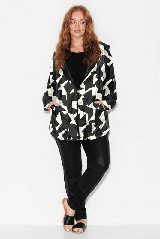 model wears plus size printed raincoat with jagged geo black and bone lo-fi print