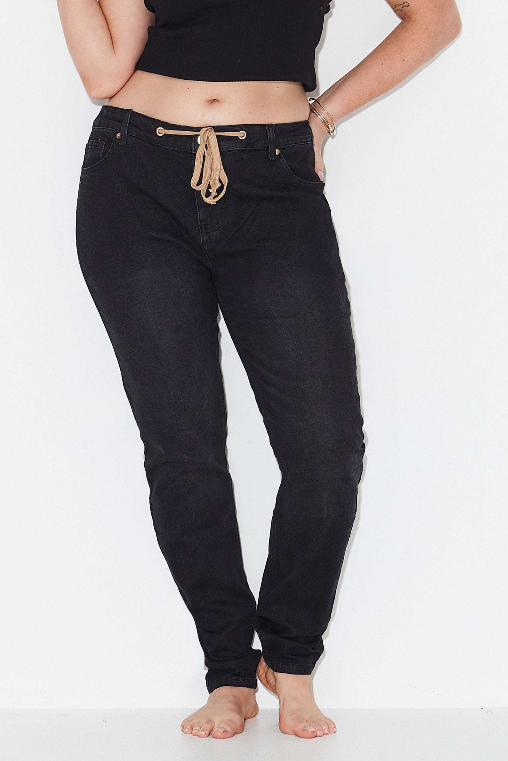 Model wears black slim leg size 16 jeans