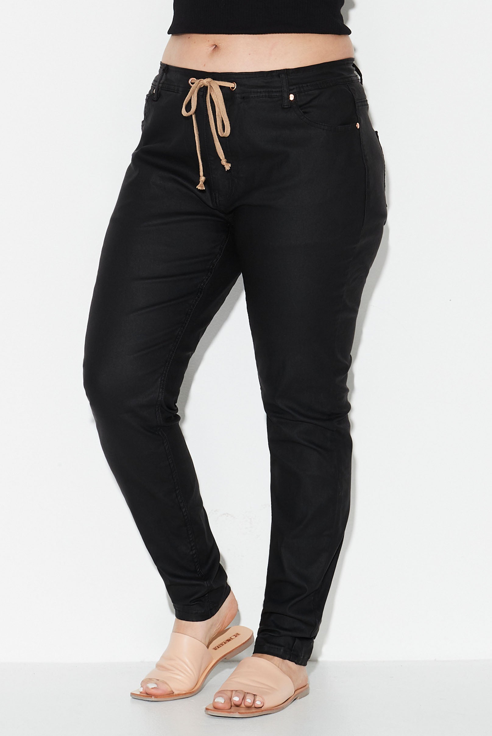Model wears black coated denim plus size jeans 