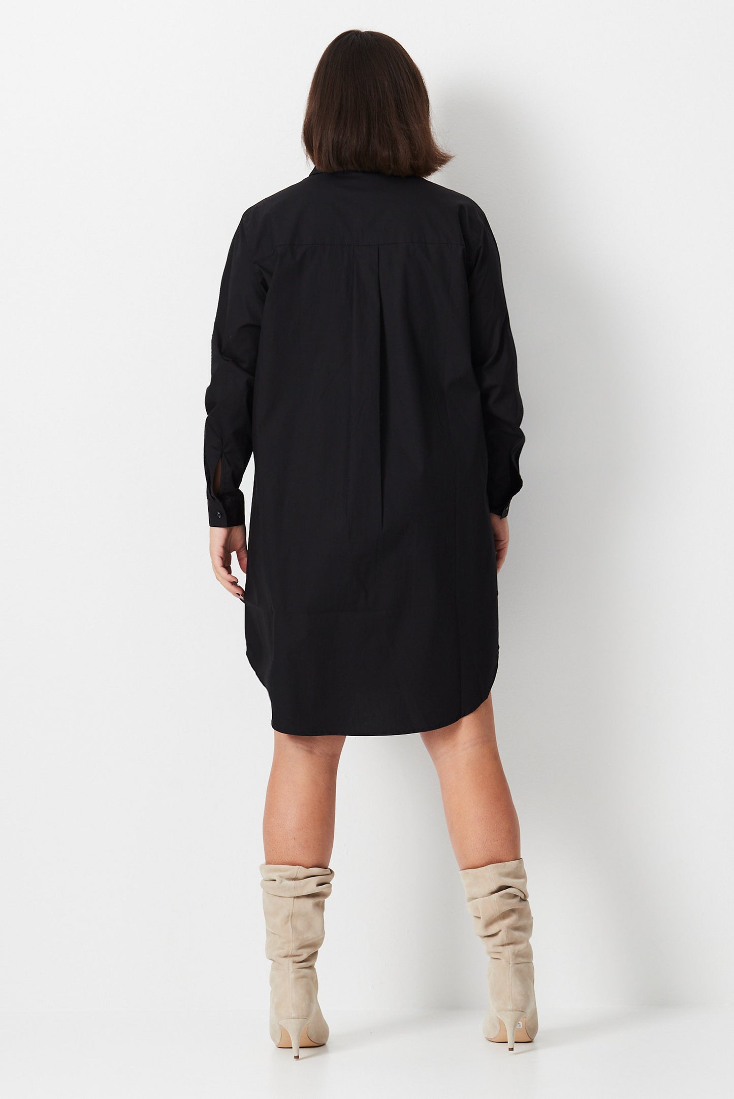 Model wears black plus size shirt dress made from organic cotton