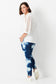 Model wears plus size blue shibori denim jeans. with elastic waist and tapered leg.