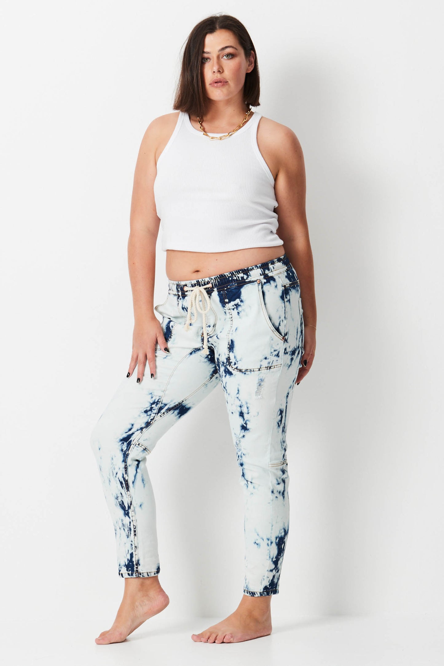 Model wears plus size white jeans with shibori wash
