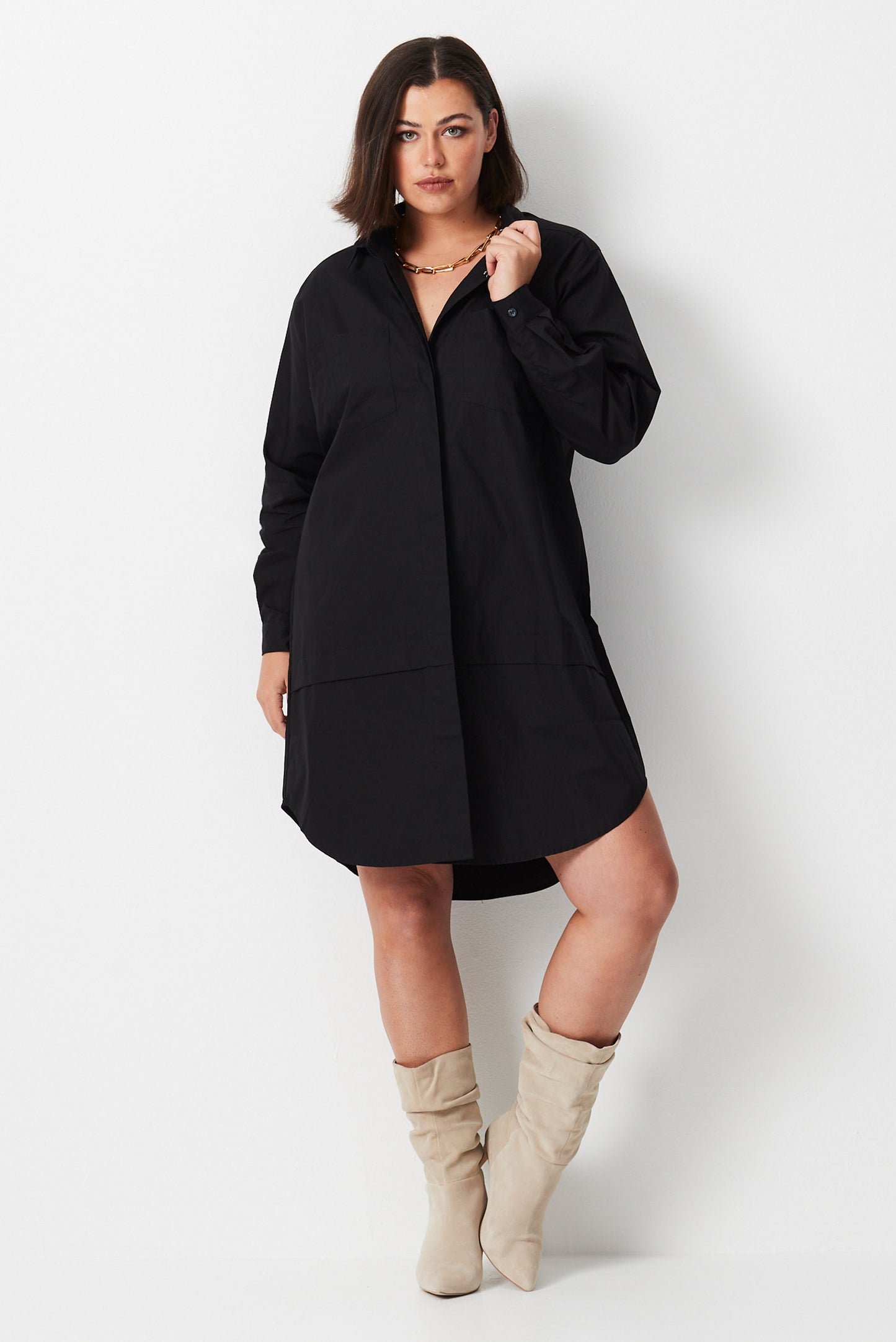 Model wears black plus size shirt dress made from organic cotton