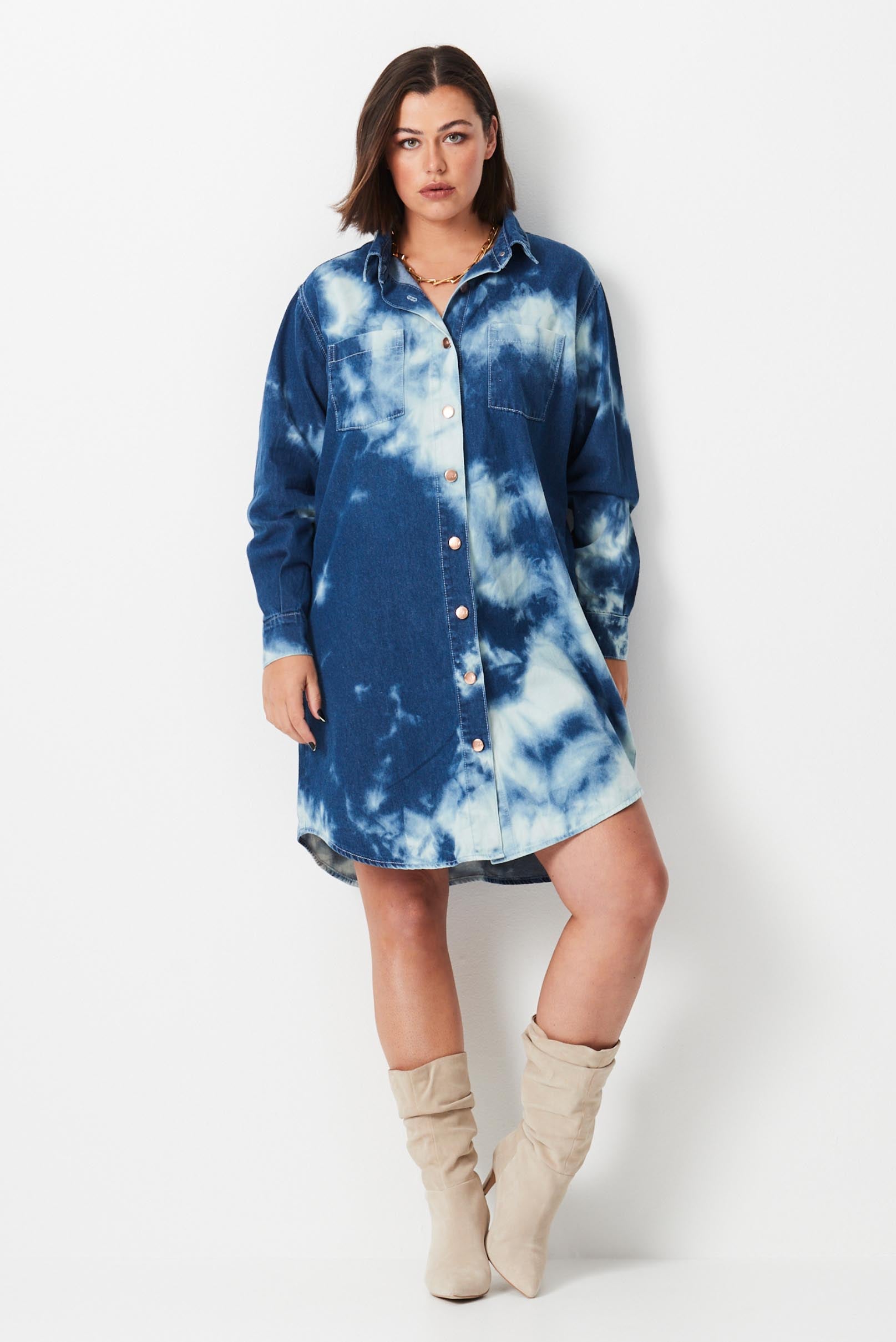 Model wears plus size shirt dress made from blue and white shibori dye denim