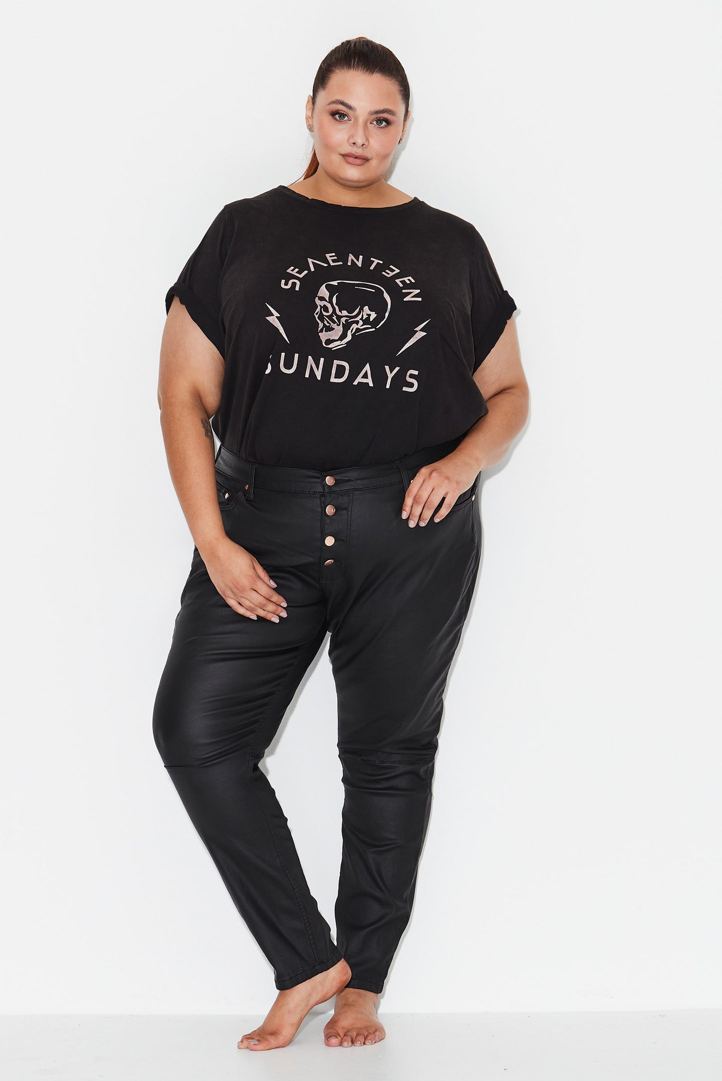 Model wears black plus size 20 jeans with exposed button front 