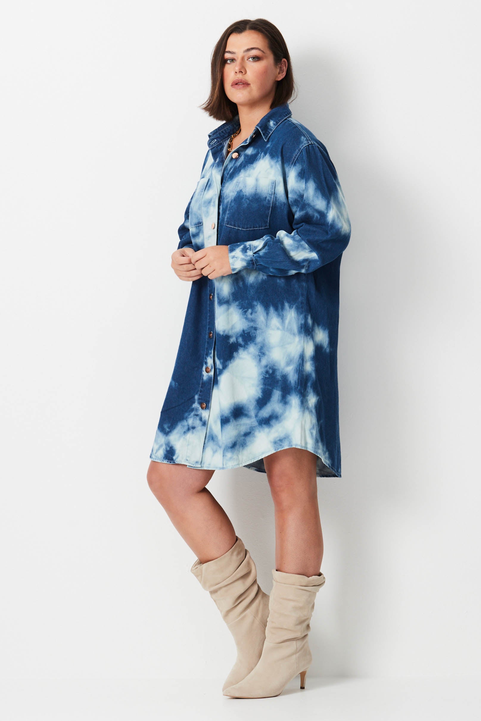 Model wears blue and white shibori tie dye plus size denim shirt dress 